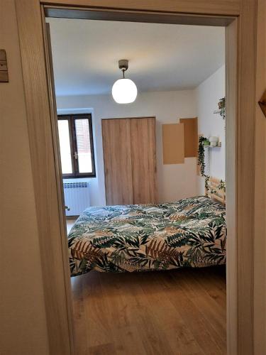 a bedroom with a bed and a large mirror at Casa MAGNA in Vezza dʼOglio