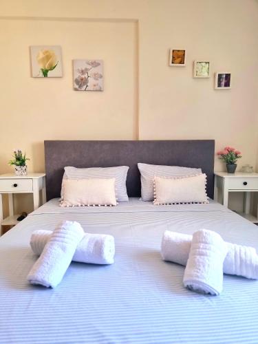 a bed with three pillows on top of it at Nice apartment with amazing views in Kriopigi