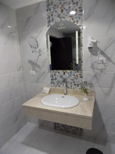 a bathroom with a sink and a mirror at Jewel Sharm El Sheikh Hotel in Sharm El Sheikh
