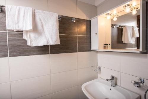 a bathroom with a sink and a mirror at Elena Studios in Athanion