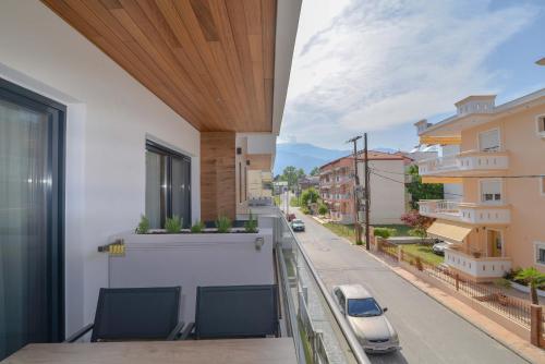 a balcony with chairs and a view of a street at Anassa Suites in Leptokaria
