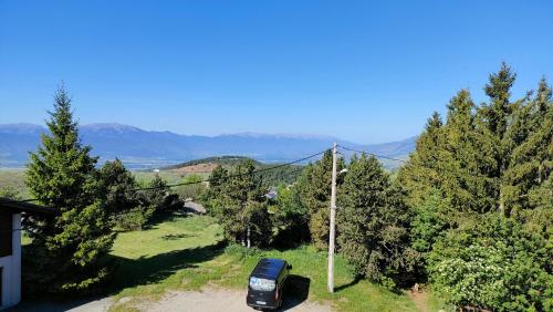 a car parked on a dirt road next to trees at Appartement type chalet montagne avec SPA à 1750m in Égat
