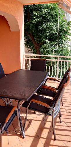 a black table and chairs on a patio at Apartment Bellavita Senj in Senj