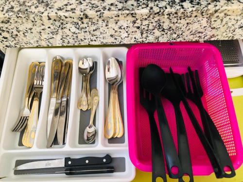 a plastic container filled with utensils on a counter at HOUSE l impérial pour vacance in Aourir