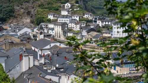 a town with white buildings on a mountain at Apartamentos Mar y Sol in Luarca