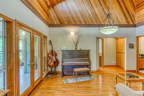 a living room with a piano and a table at Cascadel Haven in North Fork