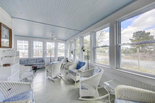 a living room with white chairs and windows at Town of Rehoboth Beach 42 Surf Ave in Rehoboth Beach
