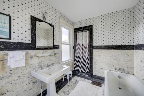 a bathroom with a sink and a tub and a mirror at Town of Rehoboth Beach 42 Surf Ave in Rehoboth Beach