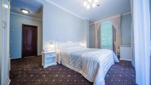 a bedroom with a bed and a dresser at Fenix in Vinnytsya