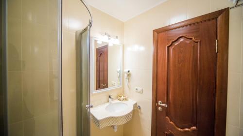 a bathroom with a sink and a shower at Fenix in Vinnytsya