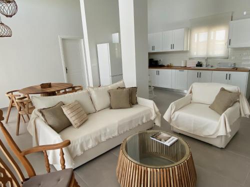 a living room with a couch and chairs and a table at Alykes Beachside Stylish Villas with Private Pool South Rhodes in Lachania