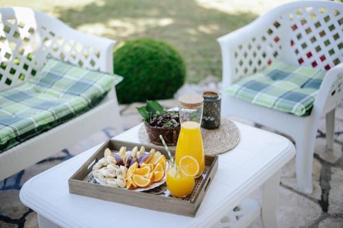 a tray of food on a table with orange juice at Markovic Village Apartments in Ulcinj