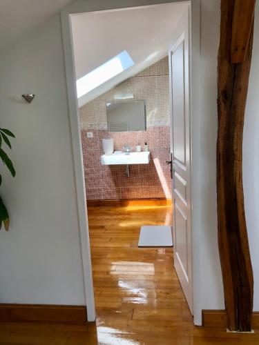 a bathroom with a sink and a mirror at L'adret du bois in Sames