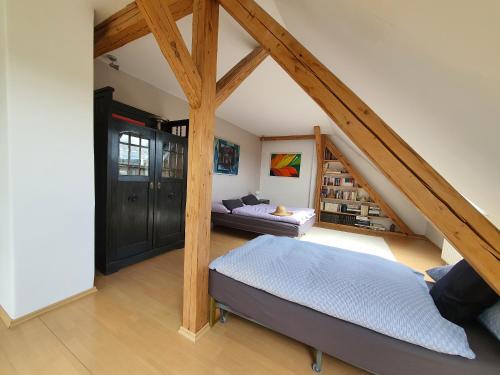 a attic room with a bed and a couch at Cottage next Svihov castle in Švihov