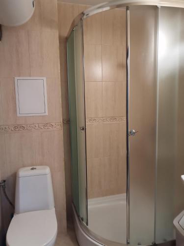 a bathroom with a glass shower with a toilet at Апартамент Весела-Хоризонт in Sozopol