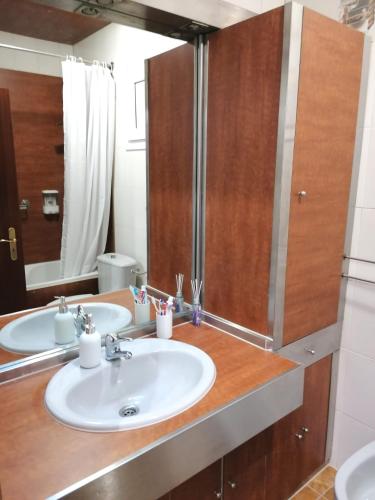 a bathroom with two sinks and a mirror at Trajadinha B in Caminha in Caminha