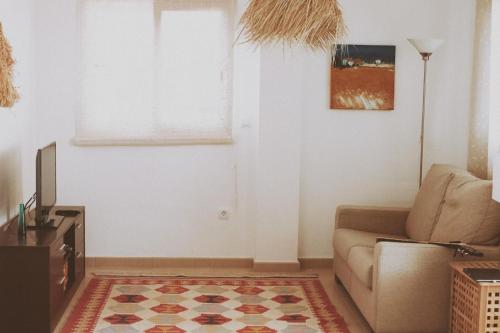 a living room with a couch and a window at Golf and Relax, Modern 2 bedroom appartement Haciënda Riquelme Golf Atlantico in Sucina