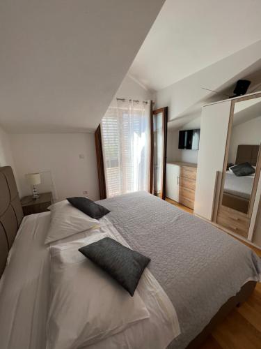 a bedroom with a large bed with two pillows on it at Luxury apartman Iris in Hvar
