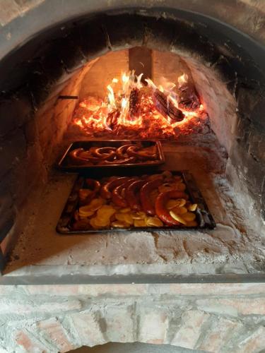 a brick oven with some food in it at Varga Vendégház in Tótszerdahely