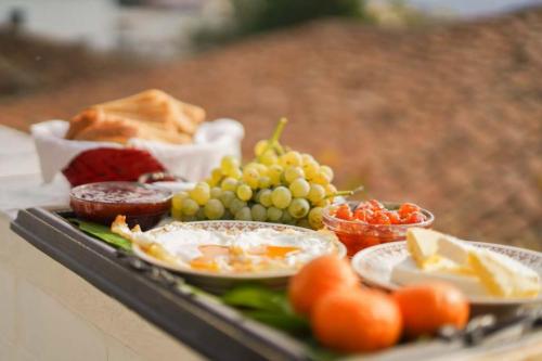 a tray with different types of food on a table at Tomor Shehu Guest House in Berat