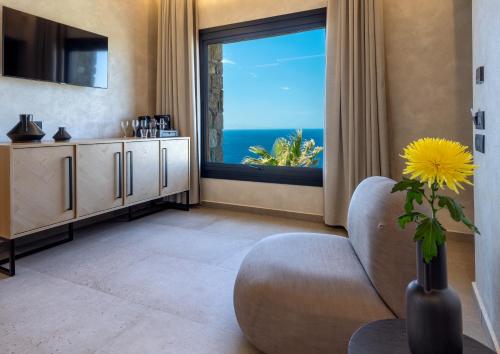 a living room with a view of the ocean at Tropicana Hotel , Suites & Villas Mykonos in Paradise Beach