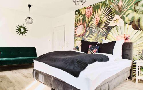 a bedroom with a large bed and a green couch at Mein Eifel Ferienhaus Altes Pfarrhaus in Dahlem