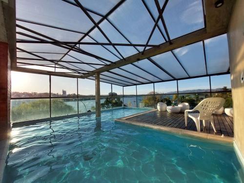 a swimming pool with a view of the water at Costalago Suites in Villa Carlos Paz