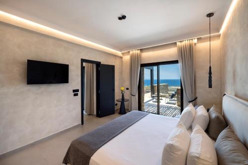 a hotel room with a bed and a television at Tropicana Hotel , Suites & Villas Mykonos in Paradise Beach