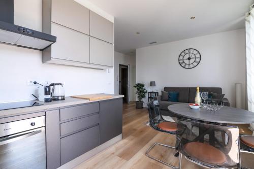 a kitchen and a living room with a table in a room at Residenza IL LAGO - Cernobbio center in Cernobbio