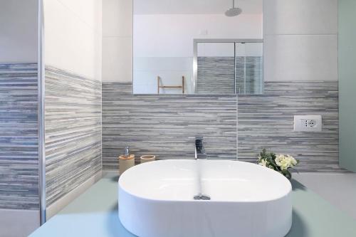 a white tub in a bathroom with a mirror at Residenza IL LAGO - Cernobbio center in Cernobbio