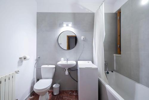 a bathroom with a toilet and a sink and a mirror at Krynica Zamkowa 48 in Krynica Zdrój