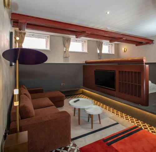 a living room with a couch and a tv at Trueman Court Luxury Serviced Apartments in Liverpool