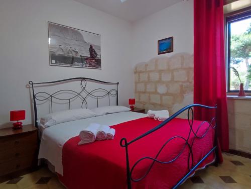 a bedroom with a bed with two towels on it at Casa Relax Acqua Marina in Favignana