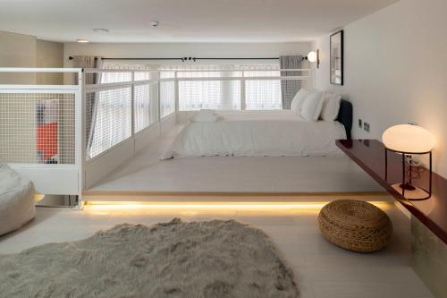 a bedroom with a large bed and a balcony at Trueman Court Luxury Serviced Apartments in Liverpool