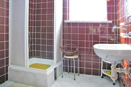 a bathroom with a shower and a sink at Cottage by Lake Dabrowa with Fishing in Wądzyn