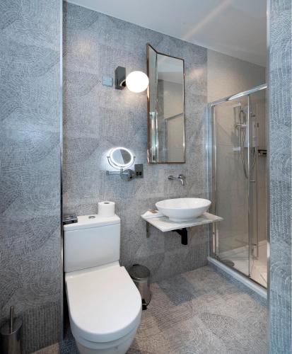 a bathroom with a toilet and a sink at Trueman Court Luxury Serviced Apartments in Liverpool