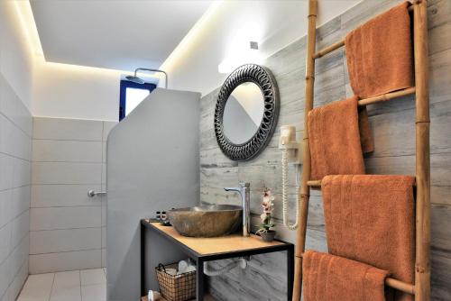 een badkamer met een wastafel en een spiegel bij Rafael Hotel-Adults Only in Lindos