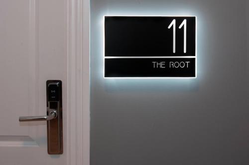 a door with a sign that reads the root at Trueman Court Luxury Serviced Apartments in Liverpool