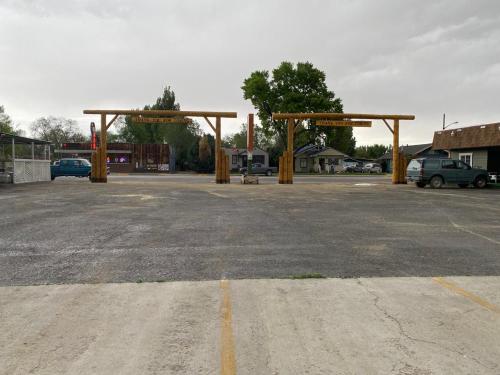 a parking lot with wooden structures in a parking lot at Western Motel in Lovell