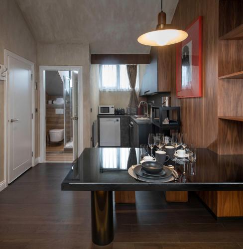 a kitchen with a table with plates on it at Trueman Court Luxury Serviced Apartments in Liverpool
