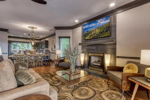 a living room with a fireplace and a tv on the wall at The Great Escape chalet in Sevierville