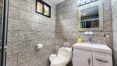 a bathroom with a toilet and a sink at The Residence by Villa Alejandro in Boquete