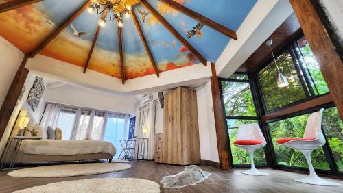 a bedroom with a ceiling with a painting on it at The Residence by Villa Alejandro in Boquete