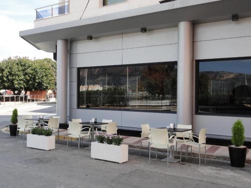 a group of tables and chairs outside of a building at Nou Avenida in Gata de Gorgos