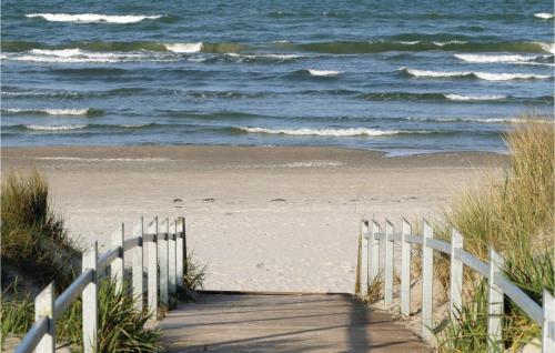a wooden path leading to a beach with the ocean at Baltic in Binz