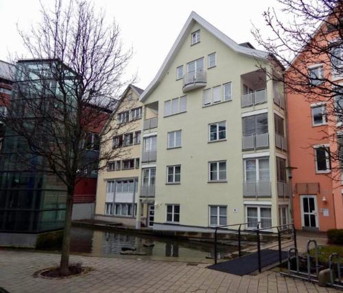 a group of buildings next to a body of water at FREE Apartment - Obere Wässere in Reutlingen