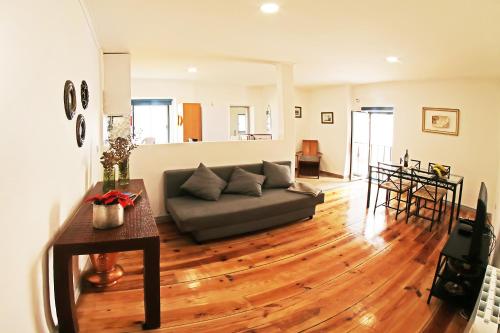 a living room with a couch and a wooden floor at SweetHome at Alfama's Heart in Lisbon