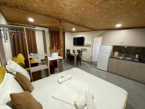 a kitchen and a living room with a white table at Full Moon Apartments in Ksamil