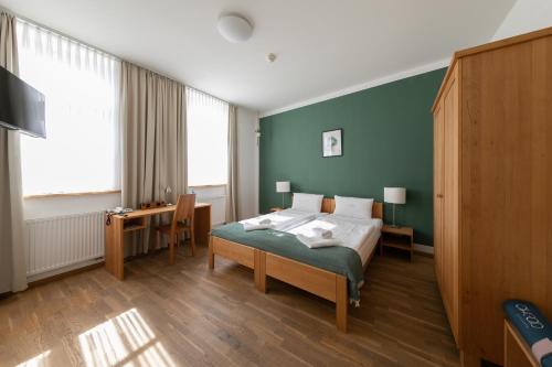 a bedroom with a bed and a desk in it at ahead burghotel in Lenzen
