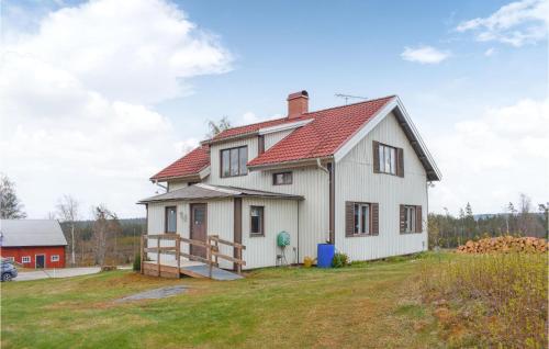 a white house with a red roof at 4 Bedroom Stunning Home In Åsenhöga in Åsenhöga